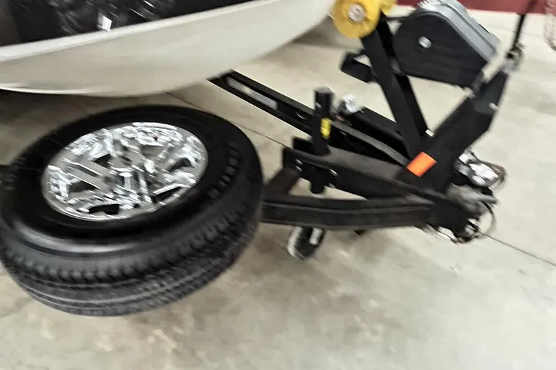 Slide: The Image of 2024 Ranger 1850MS Reata trailer with chrome wheel and black frame in a garage. - 42