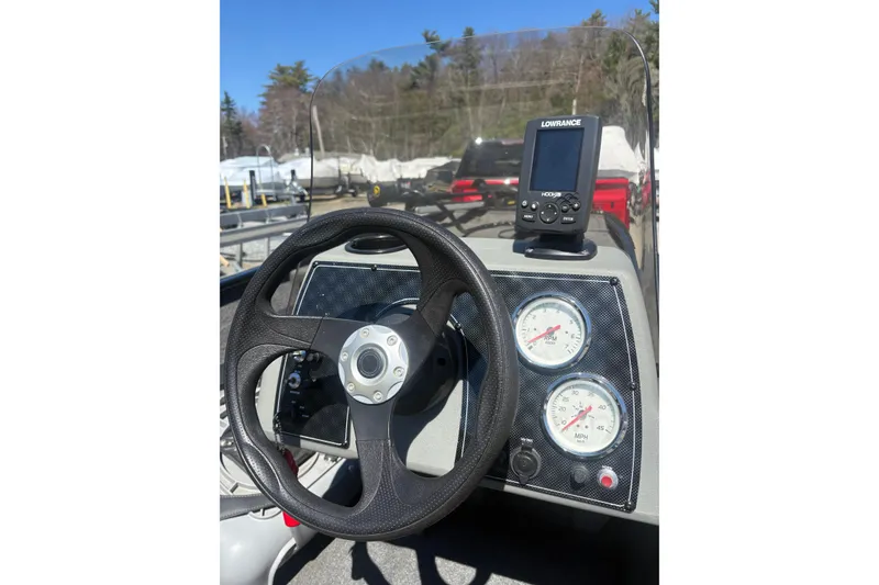 Slide: The Image of 2018 Tracker Pro 160 boat dashboard with steering wheel and Lowrance fish finder. - 4