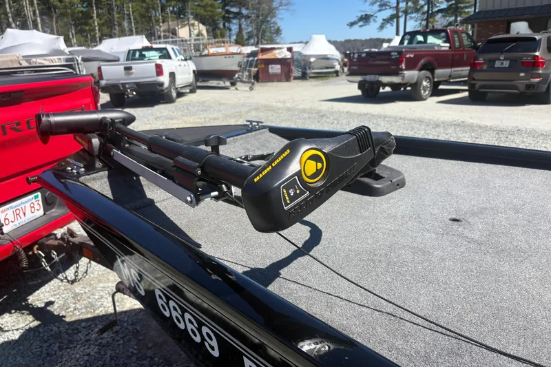 Slide: The Image of 2018 Tracker Pro 160 boat with trolling motor in a parking lot. - 7