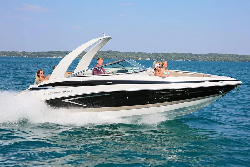 Slide: The Image of Manufacturer Provided Image: 2025 Crownline 278 SS speedboat cruising on a clear blue lake with passengers. - 2