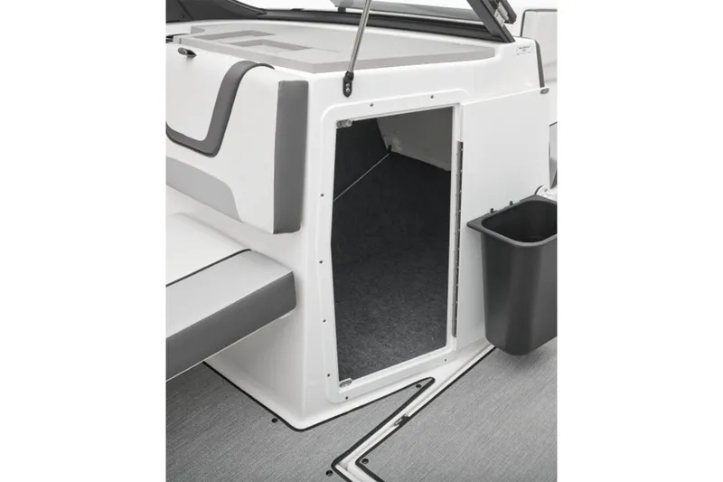 Slide: The Image of Yamaha Boats SX220 2026 storage area with gray carpet flooring. - 5