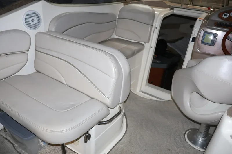 Slide: The Image of Interior of 2006 Larson Cabrio 240 boat with beige seating and dashboard. - 16