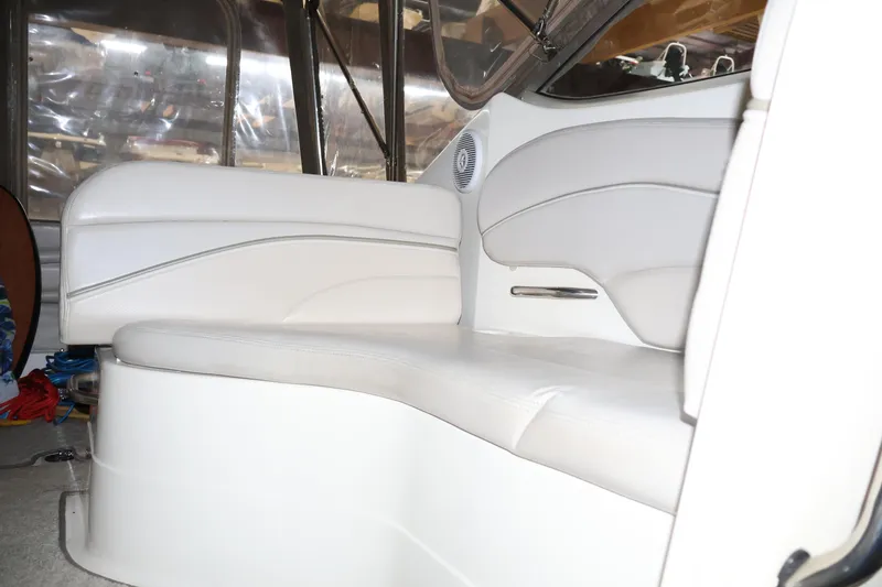 Slide: The Image of 2006 Larson Cabrio 240 boat interior with white seating and sleek design. - 18