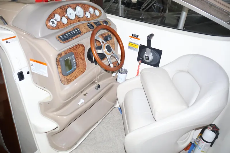 Slide: The Image of 2006 Larson Cabrio 240 boat cockpit with steering wheel and control panel. - 20