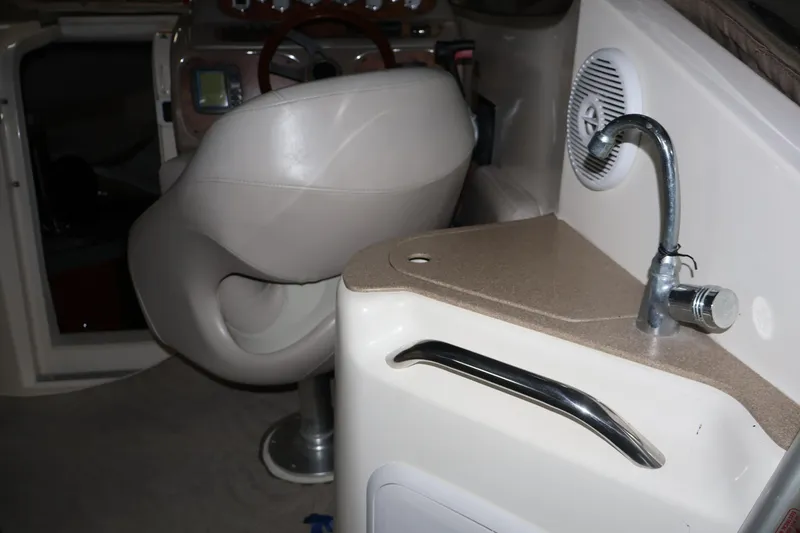 Slide: The Image of Interior of 2006 Larson Cabrio 240 boat with steering seat and sink area. - 21