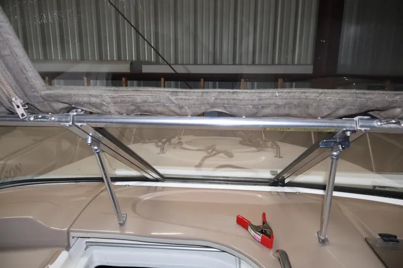 Slide: The Image of 2006 Larson Cabrio 240 boat interior with windshield and canopy support. - 22
