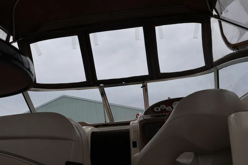 Slide: The Image of Interior view of a 2006 Larson Cabrio 240 boat cockpit with dashboard and seating. - 32
