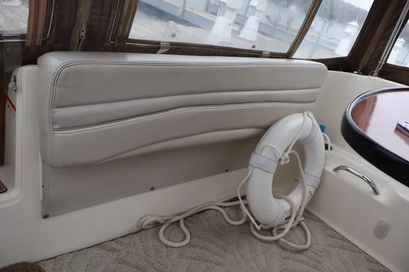 Slide: The Image of Interior of 2006 Larson Cabrio 240 boat with life preserver and seating area. - 35