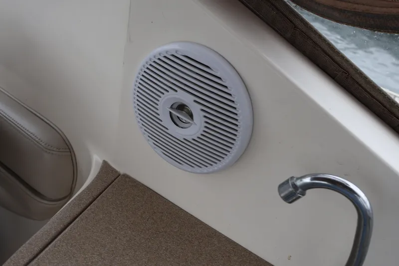 Slide: The Image of 2006 Larson Cabrio 240 boat interior with speaker and faucet detail. - 42