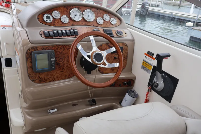 Slide: The Image of 2006 Larson Cabrio 240 boat dashboard with steering wheel and control panel. - 5