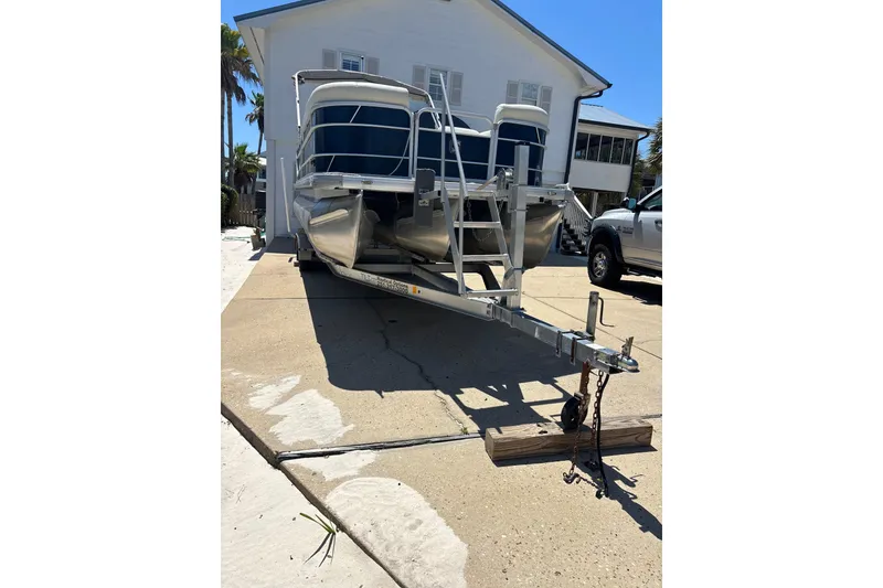 Slide: The Image of 2018 Godfrey Sweetwater 2486 C pontoon boat on trailer, parked in driveway. - 5