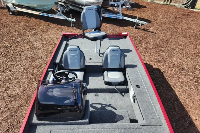 Slide: The Image of 2026 Lowe Skorpion 17 boat interior with seating and steering console. - 10