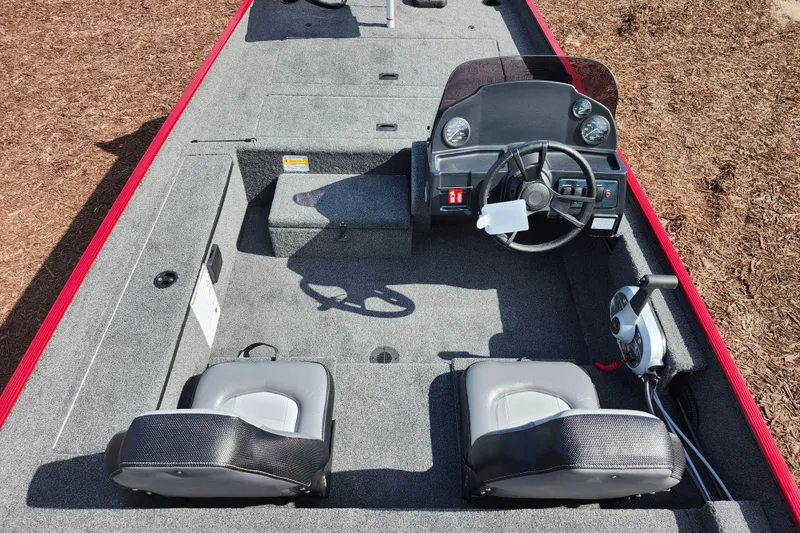 Slide: The Image of 2026 Lowe Skorpion 17 boat interior with steering console and seating, featuring gray upholstery. - 13