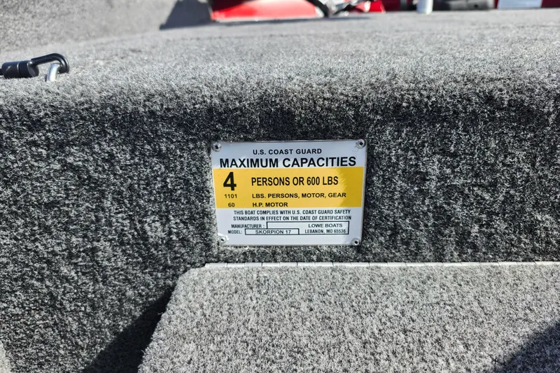 Slide: The Image of U.S. Coast Guard capacity label on 2026 Lowe Skorpion 17 boat, indicating 4 persons or 600 lbs. - 15