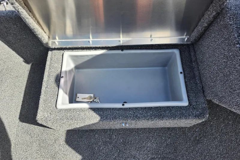 Slide: The Image of Open storage compartment in 2026 Lowe Skorpion 17 boat with keys inside. - 20