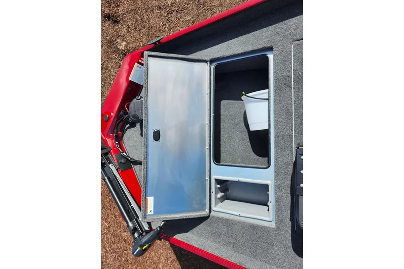 Slide: The Image of Open storage compartment on 2026 Lowe Skorpion 17 boat, featuring red and gray interior. - 22
