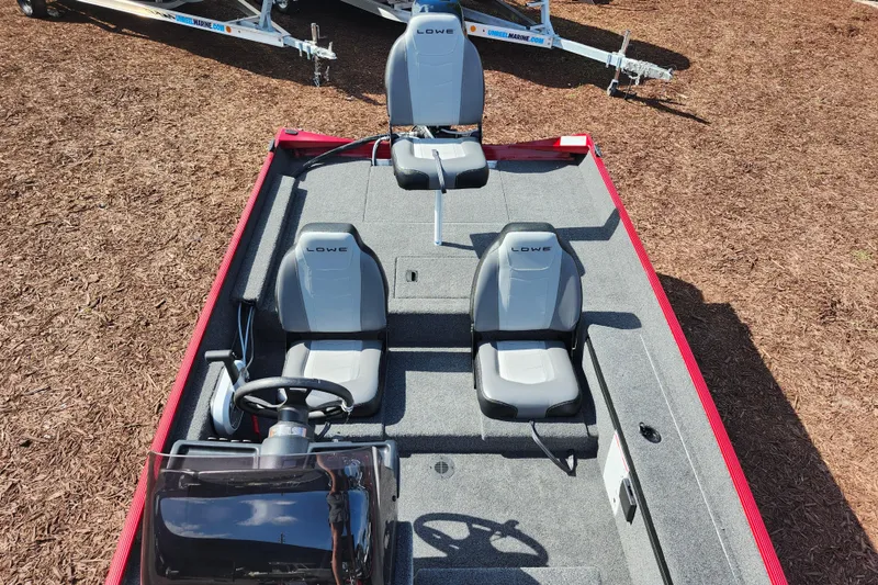 Slide: The Image of 2026 Lowe Skorpion 17 boat interior with three gray seats and steering console. - 24