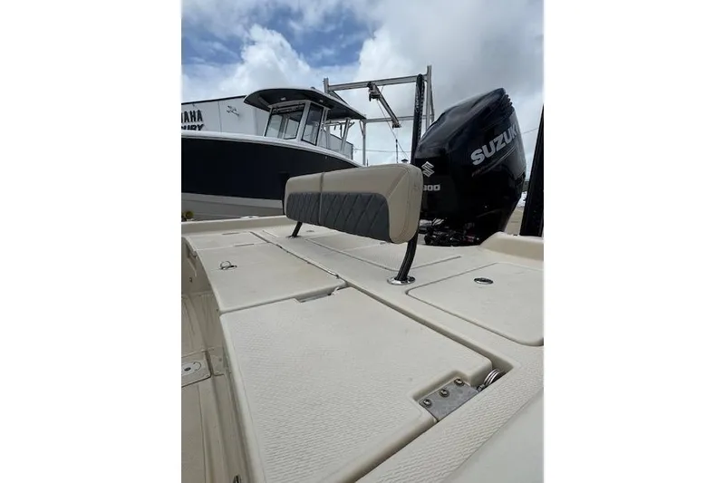 Slide: The Image of 2019 Blue Wave 2400 PureBay boat with Suzuki engine, docked under cloudy sky. - 11