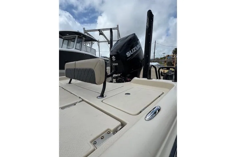 Slide: The Image of 2019 Blue Wave 2400 PureBay boat with Suzuki 300 engine, beige deck, and cushioned seating. - 12