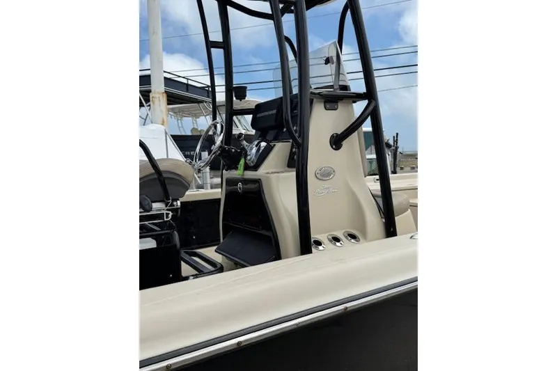 Slide: The Image of 2019 Blue Wave 2400 PureBay boat console with steering wheel and controls. - 16