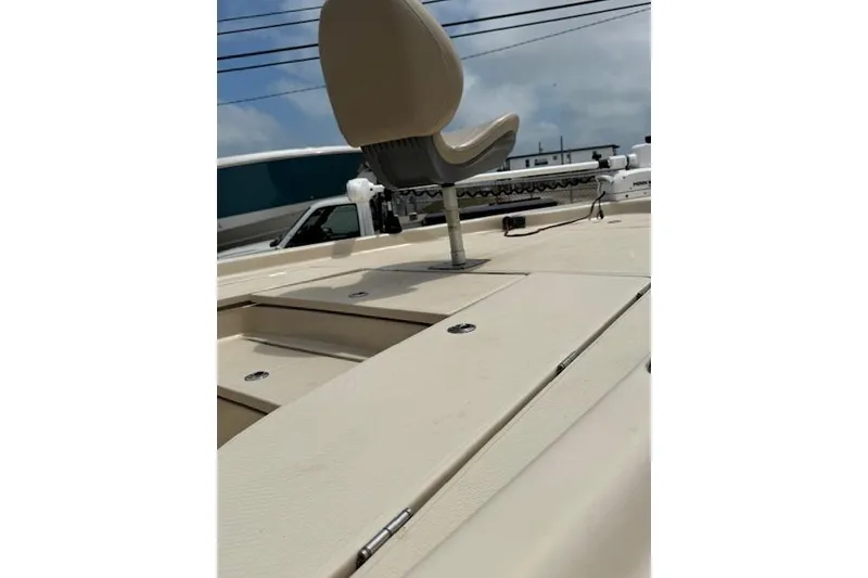 Slide: The Image of 2019 Blue Wave 2400 PureBay boat deck with seating, under a clear sky. - 19