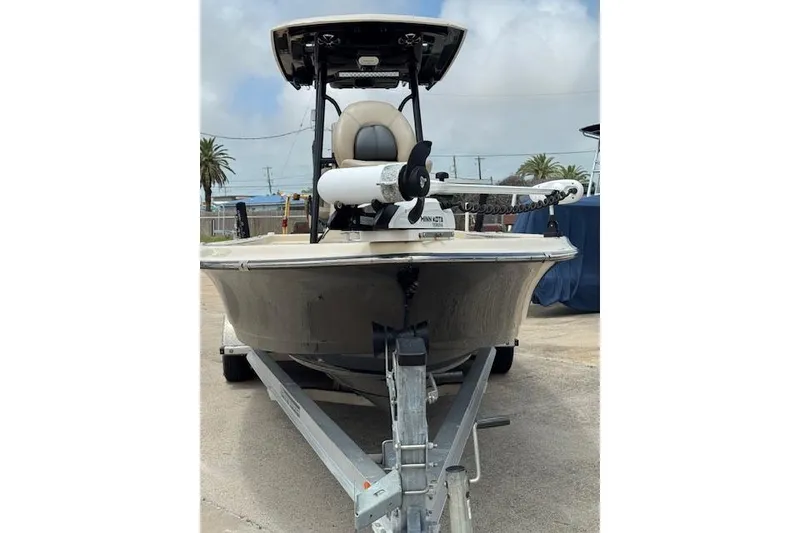 Slide: The Image of 2019 Blue Wave 2400 PureBay boat on trailer, front view, outdoors. - 6