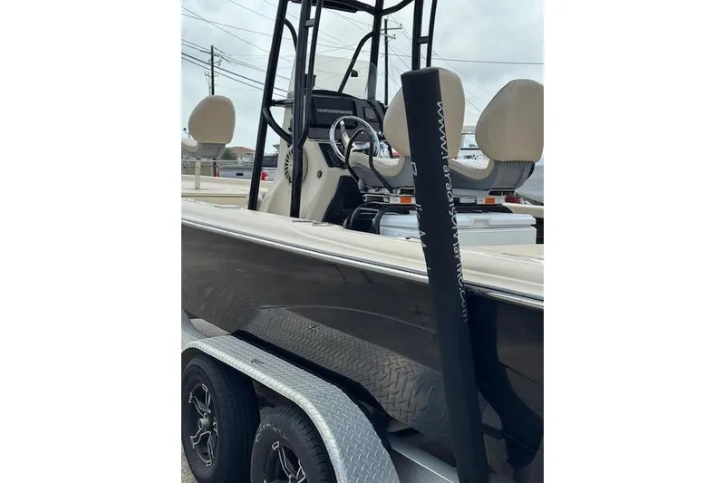 Slide: The Image of 2019 Blue Wave 2400 PureBay boat on trailer, featuring dual seats and steering console. - 7