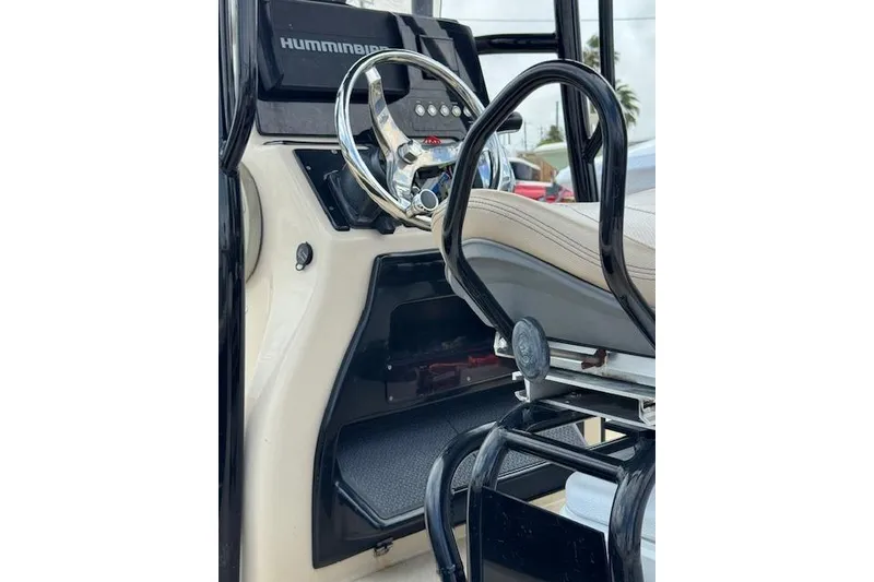 Slide: The Image of 2019 Blue Wave 2400 PureBay boat console with steering wheel and seating. - 9