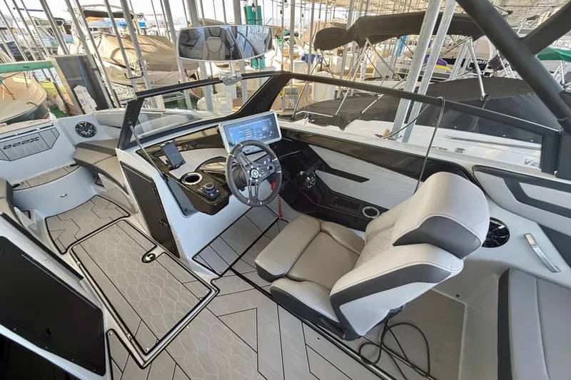 Slide: The Image of 2024 Yamaha Boats 222XE interior with modern dashboard and comfortable seating. - 10