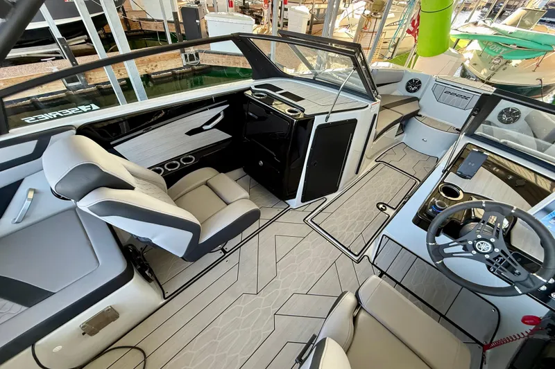 Slide: The Image of 2024 Yamaha Boats 222XE interior with modern seating and sleek dashboard design. - 11