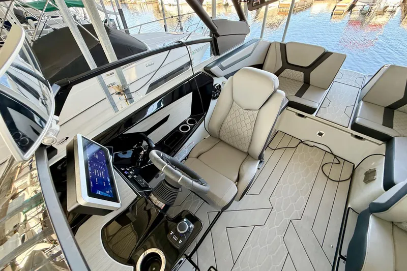 Slide: The Image of 2024 Yamaha Boats 222XE cockpit with modern dashboard and luxurious seating. - 15
