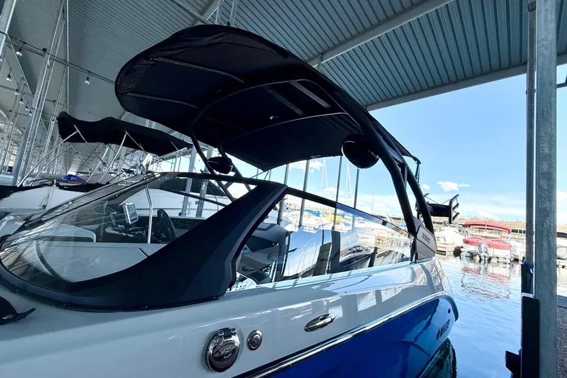 Slide: The Image of 2024 Yamaha Boats 222XE under a marina canopy, showcasing sleek design and modern features. - 21