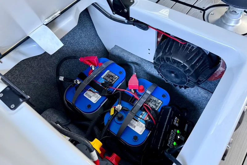 Slide: The Image of 2024 Yamaha Boats 222XE battery compartment with dual batteries and wiring setup. - 26