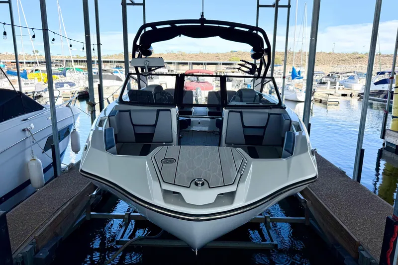 Slide: The Image of 2024 Yamaha Boats 222XE docked at marina, showcasing sleek design and modern features. - 28
