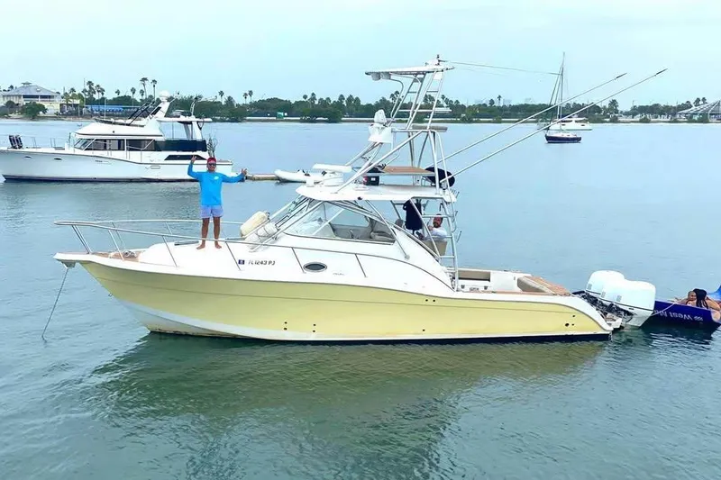 The Image of 2006 Pro-Line 35 Express boat on calm water with people onboard. - 1
