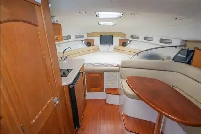 Slide: The Image of 2006 Pro-Line 35 Express cabin interior with kitchenette, seating, and wood finishes. - 3