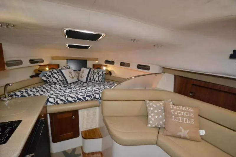 Slide: The Image of Luxurious interior of 2006 Pro-Line 35 Express boat with cozy bedding and seating area. - 5