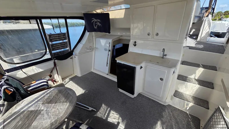 Slide: The Image of Interior of a 2001 Silverton 453 yacht with table and kitchenette. - 12