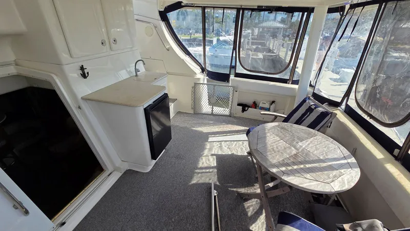 Slide: The Image of Interior of a 2001 Silverton 453 yacht with table and minibar. - 14
