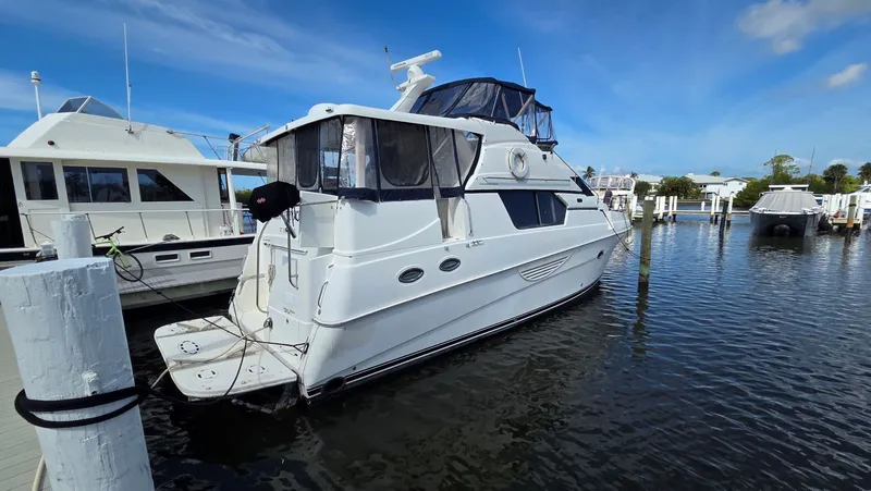 Slide: The Image of 2001 Silverton 453 yacht docked in marina under blue sky. - 2
