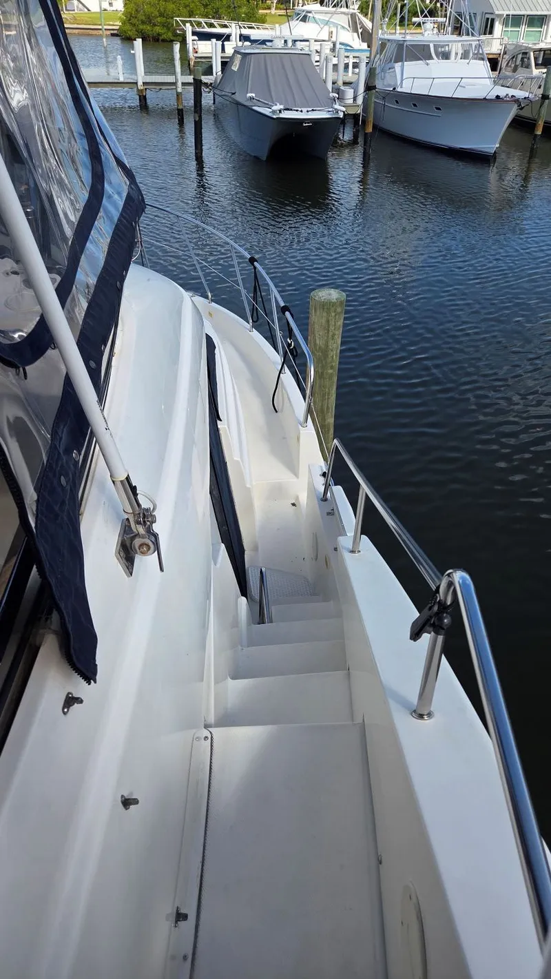 Slide: The Image of 2001 Silverton 453 yacht docked with stairway view. - 24