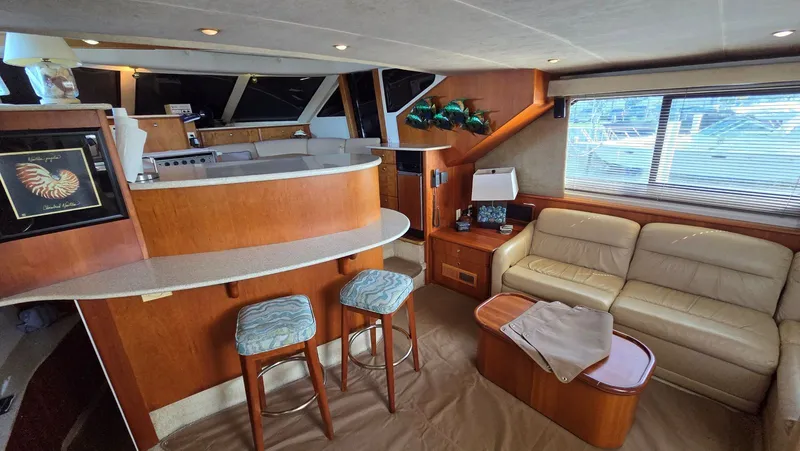 Slide: The Image of Interior of a 2001 Silverton 453 yacht with cozy seating area. - 30