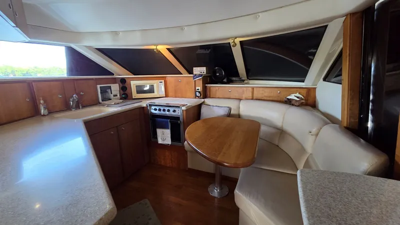 Slide: The Image of Interior of a 2001 Silverton 453 yacht with kitchen and seating area. - 35