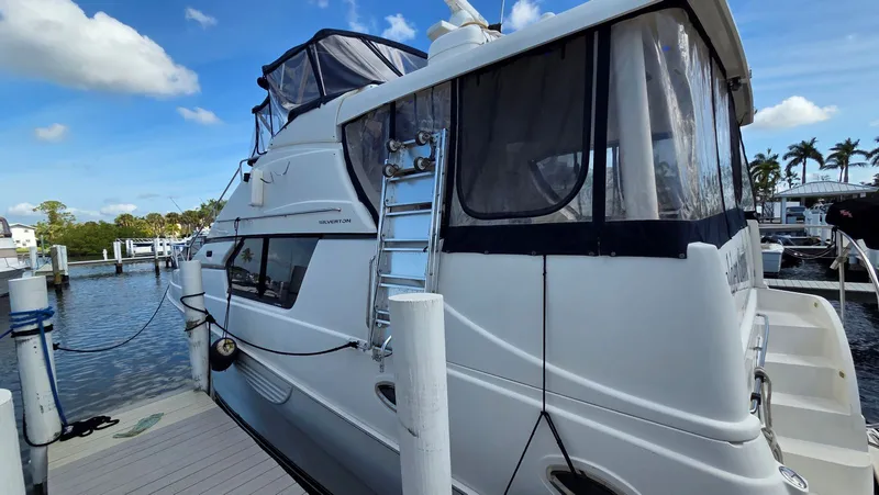 Slide: The Image of 2001 Silverton 453 yacht docked under sunny skies. - 4