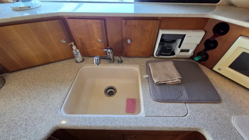 Slide: The Image of 2001 Silverton 453 yacht kitchen area with sink and coffee maker. - 40