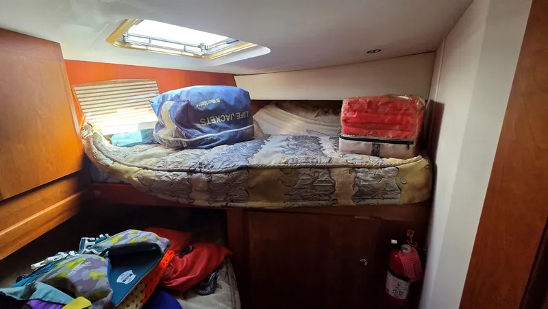 Slide: The Image of Interior of a 2001 Silverton 453 yacht with bed and life jackets. - 46