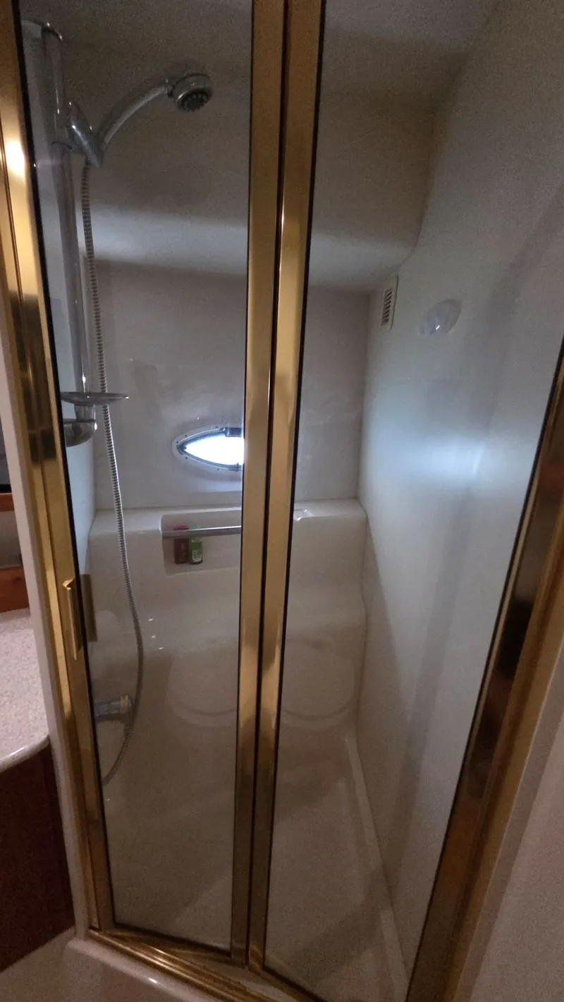 Slide: The Image of Shower in a 2001 Silverton 453 yacht with gold accents. - 48