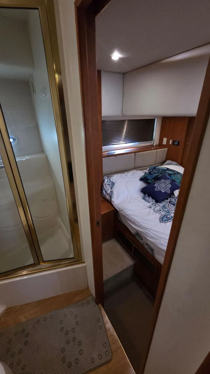 Slide: The Image of Interior of a 2001 Silverton 453 yacht featuring bedroom and shower. - 49