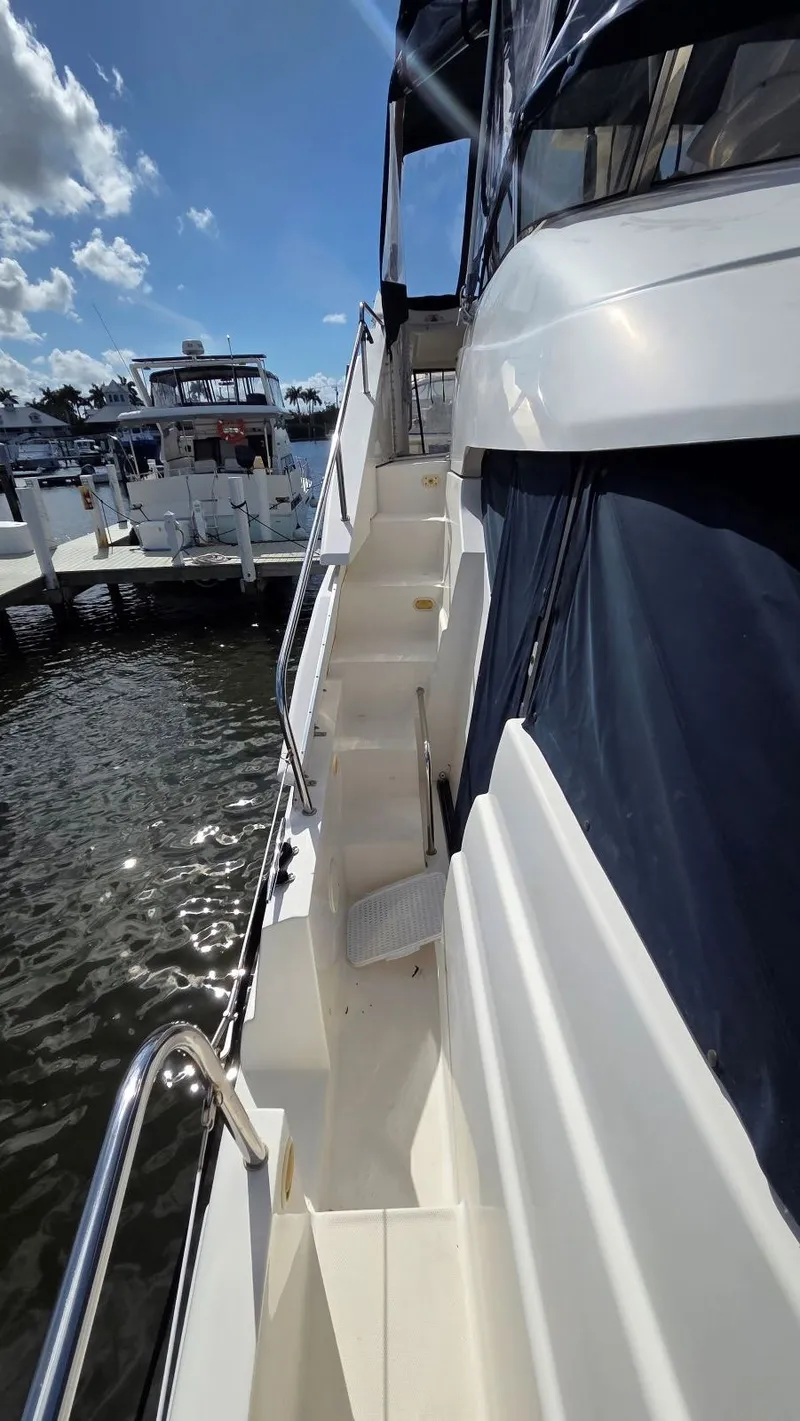 Slide: The Image of 2001 Silverton 453 yacht docked on a sunny day. - 5