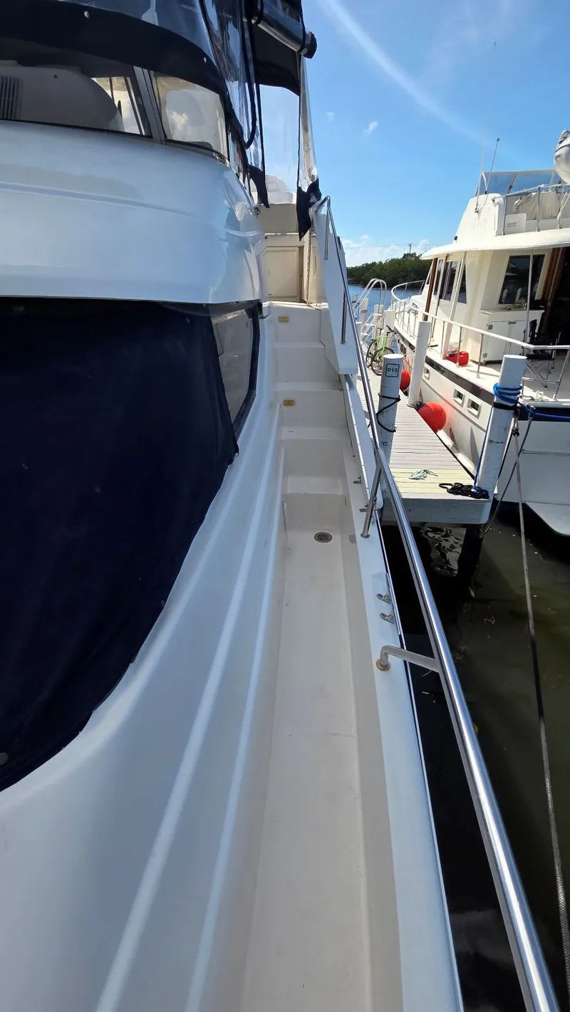 Slide: The Image of Side view of 2001 Silverton 453 yacht docked at marina. - 8